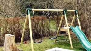 A playground with swings and a slide. - 5 Star Holiday Home in Farvang (Farvang)