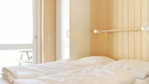 A room with a bed, wooden panel walls, and a window. - Modern Holiday Home in Faaborg With Balcony (Faaborg)