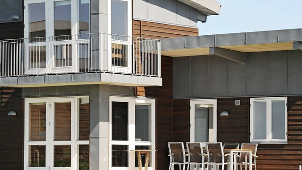 A modern two-story building with a balcony, large windows, and a wooden facade. - Modern Holiday Home in Faaborg With Balcony (Faaborg)