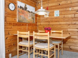 A wooden interior with a dining table, chairs, a clock, and a painting. - Reposeful Holiday Home in Skjern near Sea (Skjern)