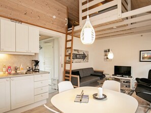 A modern interior with a kitchen, dining area, and living space. - 4 Person Holiday Home in Aeroskobing (Aeroskobing)