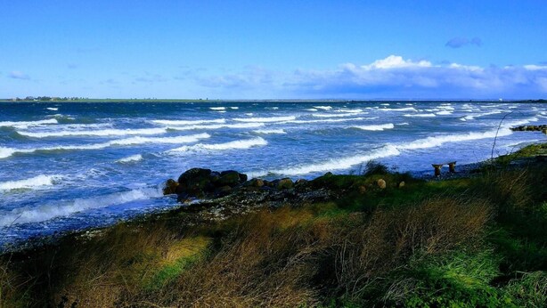 A coastal scene with waves crashing onto rocks and a clear sky. - 4 Person Holiday Home in Aeroskobing (Aeroskobing)