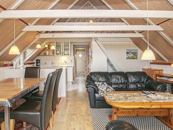A loft-style living space with a kitchen, dining area, and seating area.
