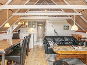A loft-style living space with a kitchen, dining area, and seating area.