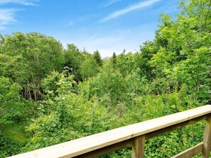 A wooden deck overlooking a dense forest. - Lovely Holiday Home in SpÃ¸ttrup near Sea (Spøttrup)