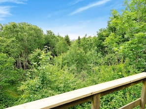 A wooden deck overlooking a dense forest. - Lovely Holiday Home in SpÃ¸ttrup near Sea (Spøttrup)