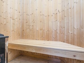 A wooden bench with a slatted design, positioned against a wall with vertical wooden planks. - 5 Star Holiday Home in Ulfborg (Ulfborg)