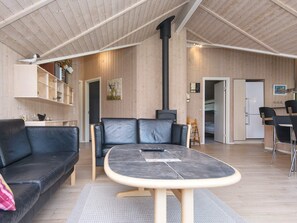 A cozy living area with a sofa, a table, and a fireplace.