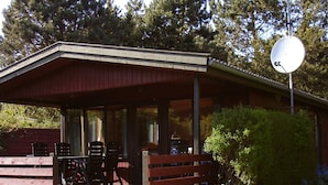 A covered outdoor area with a dining table and chairs, a barbecue grill, and a satellite dish. - 6 Person Holiday Home in Praesto (Praesto)