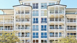 A multi-story hotel with balconies and a central atrium. - Holiday Home in Grossenbrode (Grossenbrode)