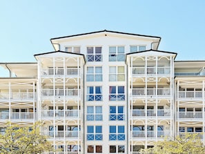 A multi-story hotel with balconies and a central atrium.