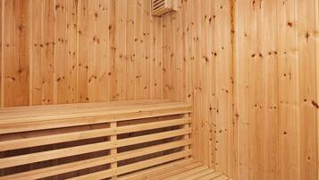 A wooden sauna with a bench and a ventilation system.