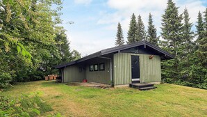 A single-story building with a flat roof, a front door, and a small porch.