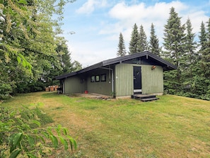 A single-story building with a flat roof, a front door, and a small porch. - 4 Person Holiday Home in Skibby (Skibby)