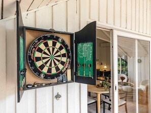A dartboard mounted on a wall with a green chalkboard behind it. - 6 Person Holiday Home in Humble (Sydlangeland)