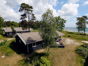 A coastal property with multiple cabins, a deck, and a view of the sea.