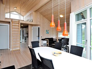 Un interior moderno con comedor, cocina y un espacio tipo loft.