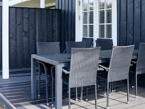 An outdoor dining area with a table and chairs. - 4 Star Holiday Home in Gjern (Gjern)