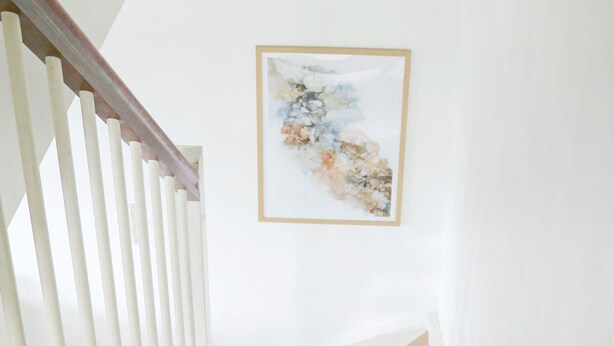 Una escalera con barandillas blancas y escalones de madera.