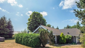 A residential house with a tiled roof, surrounded by greenery and a clear sky. - Pleasing Holiday Home in Ebeltoft near Sea (Ebeltoft)