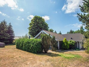 A residential house with a tiled roof, surrounded by greenery and a clear sky. - Pleasing Holiday Home in Ebeltoft near Sea (Ebeltoft)