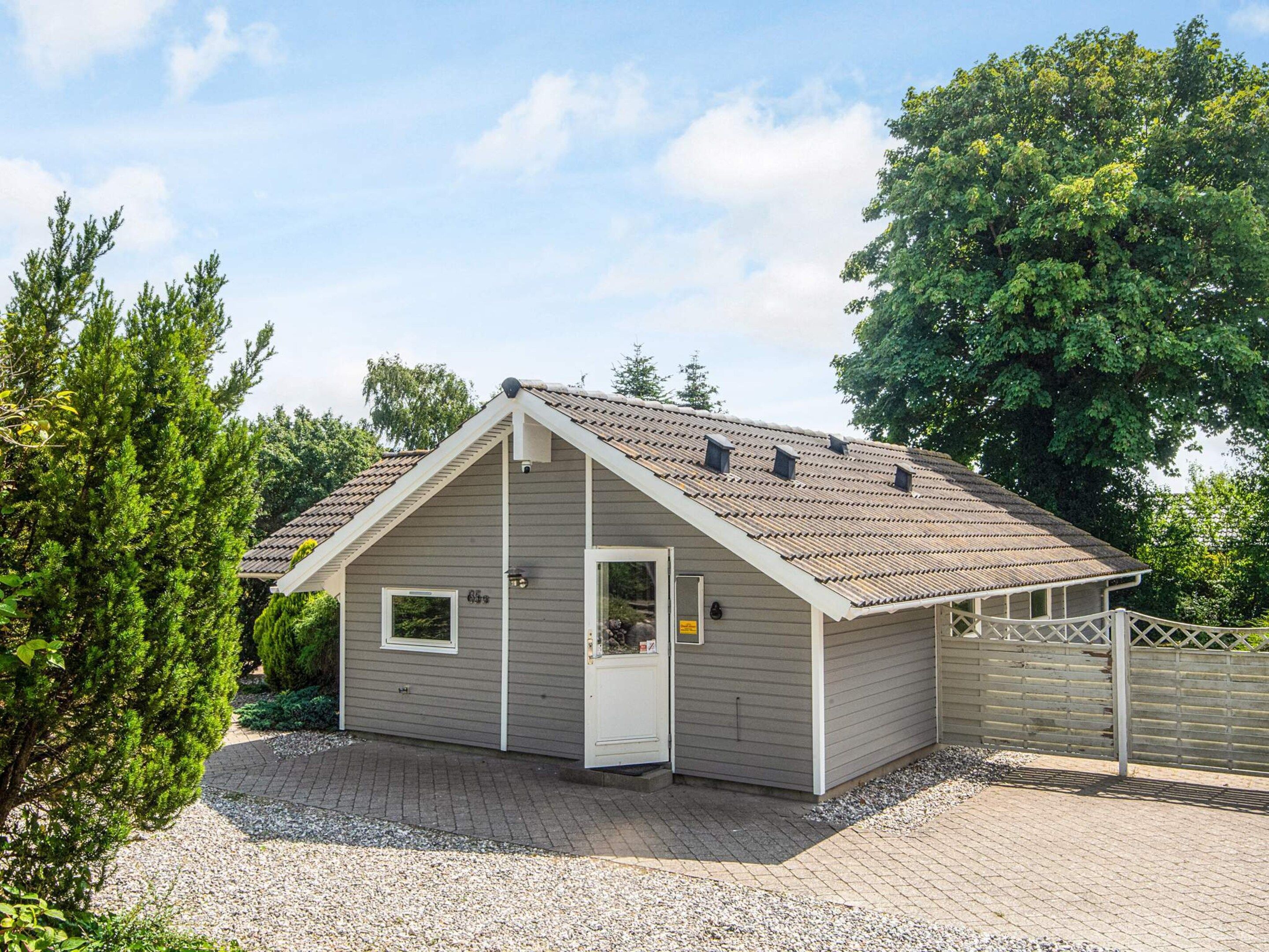 A small, single-story building with a sloped roof and a door.