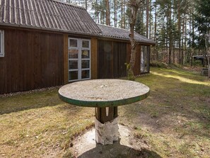A wooden building with a gravel patio and a table in front. - 7 Person Holiday Home in Kolind-by Traum (Kolind)