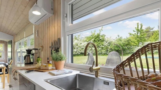A kitchen with a large window, a sink, and a coffee maker. - 14 Person Holiday Home in Ebeltoft-by Traum (Ebeltoft)