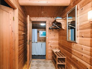 A wooden interior with a bench, a hanging clothes rack, and a mirror. - 6 Person Holiday Home in Oksbol (Oksbol)