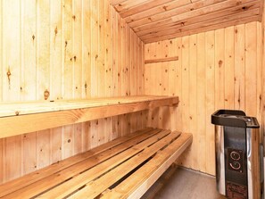A sauna with wooden benches and a control panel. - 4 Star Holiday Home in Pandrup (Pandrup)