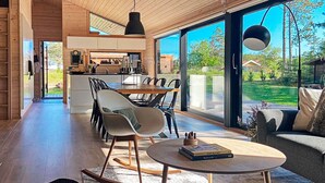 A spacious living area with a dining table, modern chairs, and a rocking chair. - 5 Star Holiday Home in Hals (Hals)