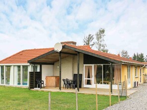 A two-story house with a red-tiled roof, a covered patio area, and a satellite dish. - 6 Person Holiday Home in Ulfborg (Ulfborg)