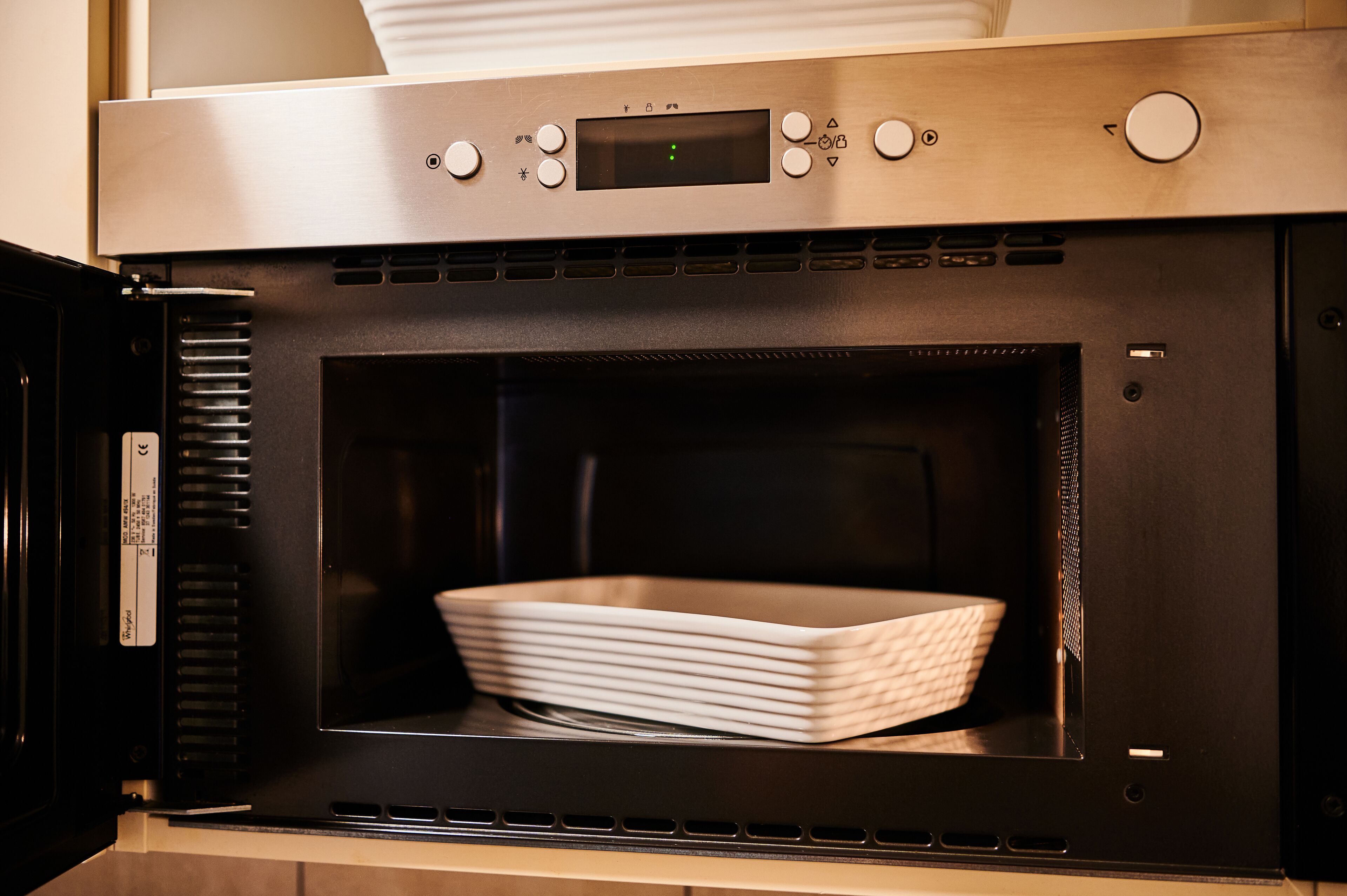 A stainless steel oven with a digital display and control buttons.