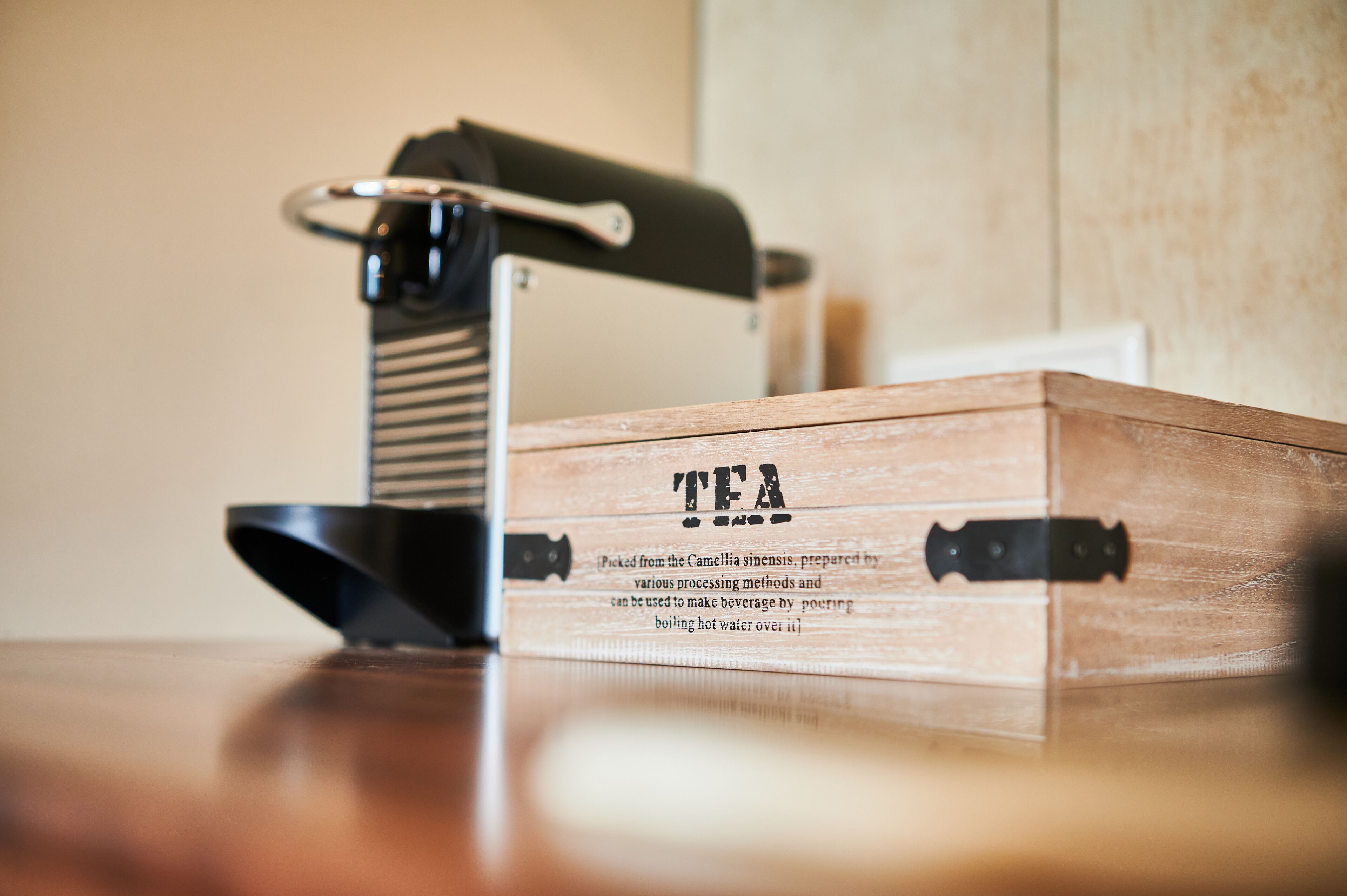 A wooden box labeled "TEA" with a tea infuser and a kettle.
