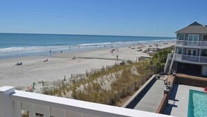 A beach view with a pool and a building with a balcony. - Admiral's Quarters II #10 - Oceanfront in Surfside Beach (Surfside Beach)