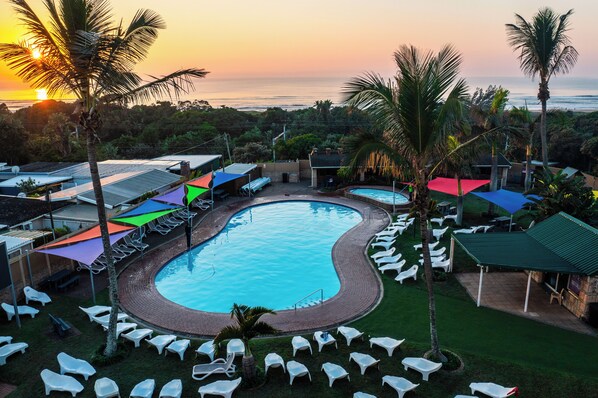 Outdoor pool, pool loungers, lifeguards on site