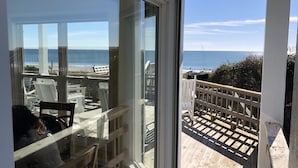 A balcony with a wooden deck and a view of the ocean. - BEAUTIFUL OCEANFRONT with gorgeous views! 2 king beds, 3 queen beds and 4 twins. (Emerald Isle)