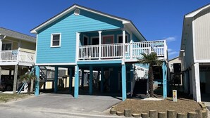 A two-story building with a balcony and a covered porch area. - Sunset Square N - Second Row Complex in Garden City Beach (Garden City)