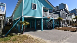 A two-story building with a balcony and a staircase leading to the upper floor. - Sunset Square N - Second Row Complex in Garden City Beach (Garden City)