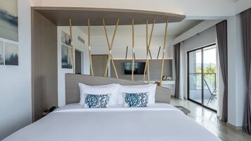 A modern hotel room with a large bed, a flat-screen TV, and a balcony with a view.