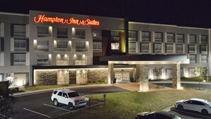 A Hampton Inn & Suites hotel with a modern design, featuring a stone facade and multiple windows. - Hampton Inn & Suites by HIlton Charlotte North I 485 (Charlotte)