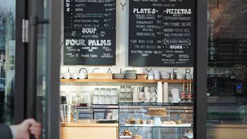 A restaurant menu board with various food options and prices.