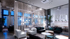 A modern interior with seating areas, tables, and decorative elements. - The Fort Sutter Sacramento, Tapestry Collection by Hilton (Sacramento)