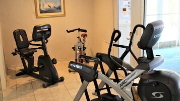 A gym with stationary bikes and exercise equipment.