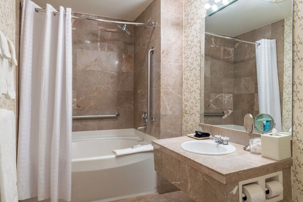 A modern bathroom with a bathtub, shower, and sink. - The Harraseeket Inn & Event House Freeport Downtown (Freeport)