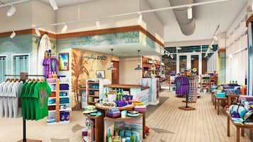 Una tienda minorista bien iluminada con suelo de madera, estantes organizados y una variedad de productos coloridos, incluyendo ropa y accesorios.