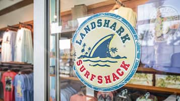 A storefront with a circular sign that reads "LANDSHARK SURFSHACK".