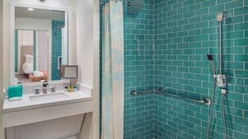 A modern bathroom with a shower area, a sink, and a mirror.