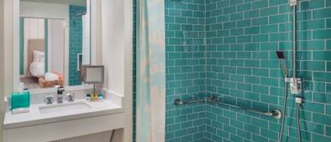 A modern bathroom with a shower area, a sink, and a mirror.