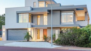 A modern two-story house with a garage, large windows, and a well-maintained front yard. - La Vacanza—Luxe Spacious Home with Ocean Views (Dunsborough)
